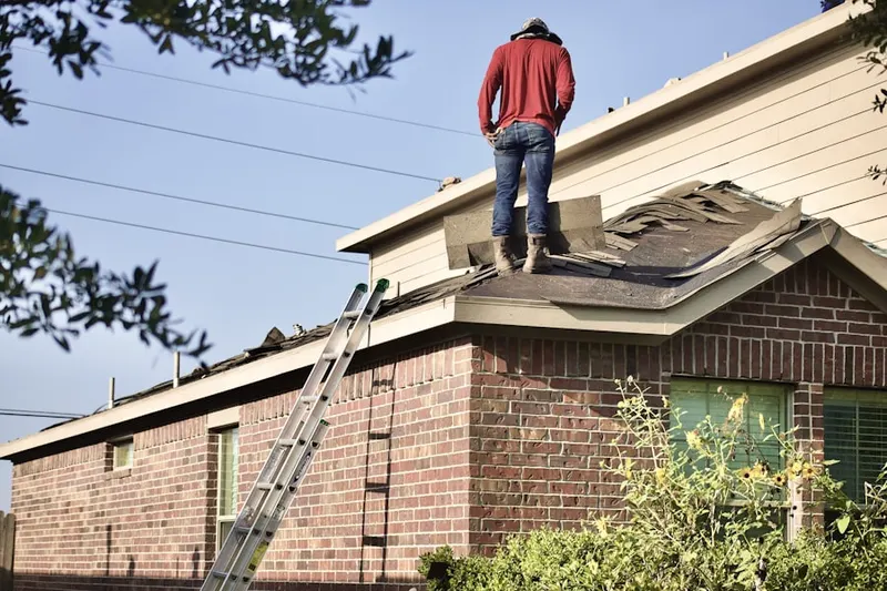 Professional roofer working on a residential roof in Oquirrh Shadows